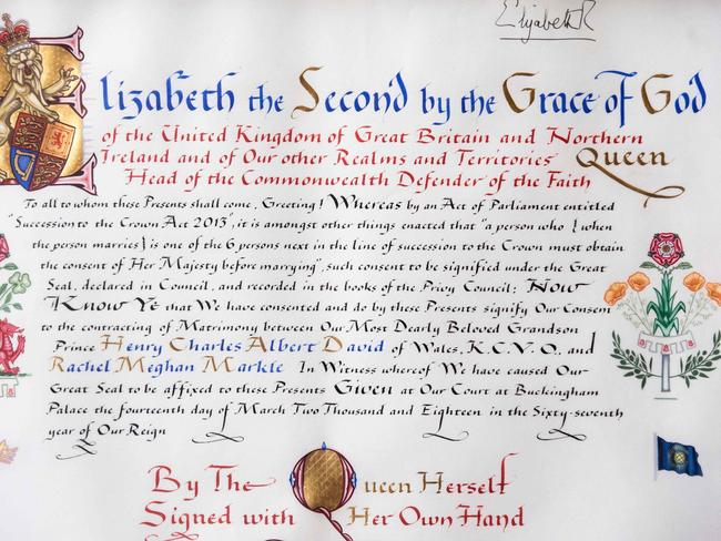 The Queen signs off with the official instrument of consent. Picture: AFP PHOTO / POOL / Victoria Jones