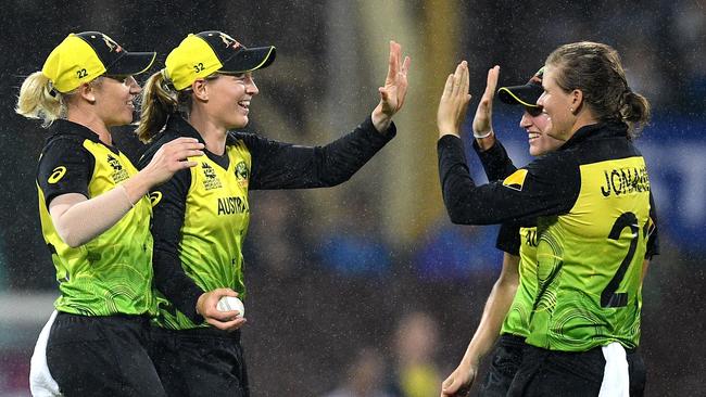 Jess Jonassen, right, celebrates with Meg Lanning after she took a catch to dismiss Chloe Tryon during the semi-final victory over South Africa, Picture: AAP