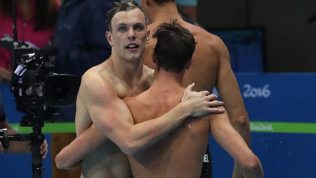 Kyle Chalmers and Cameron McEvoy embrace after the race. Picture: Adam Head