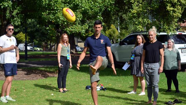 Serbian world number one tennis player Novak Djokovic kicks an Australian rules football after leaving quarantine in Adelaide on January 29. Picture: AFP