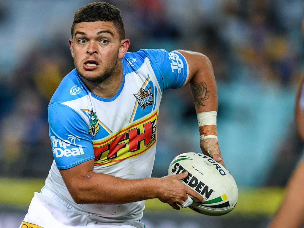 Ashley Taylor (left) of the Titans runs with the ball against the Eels during the Round 21 NRL match between the Parramatta Eels and the Gold Coast Titans at ANZ Stadium in Sydney, Saturday, August 4, 2018. (AAP Image/Brendan Esposito) NO ARCHIVING, EDITORIAL USE ONLY