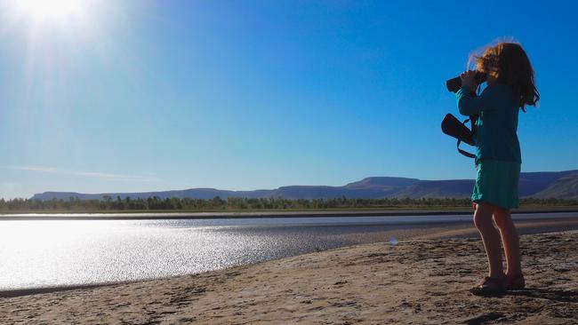 Leah McLennan’s daughter Tallula keeps a lookout for crocodiles during a family road trip along the Gibb River Road in Western Australia. Picture: Leah McLennan