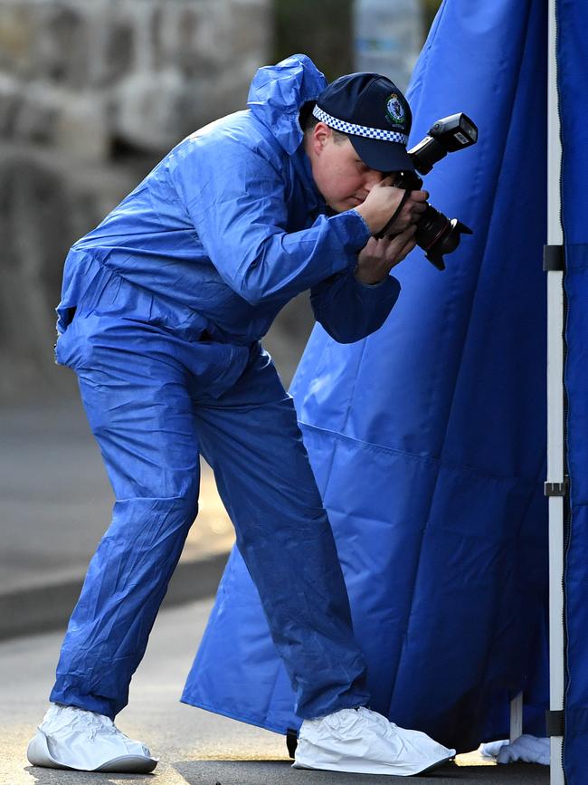 Forensic police officers at the scene last week.