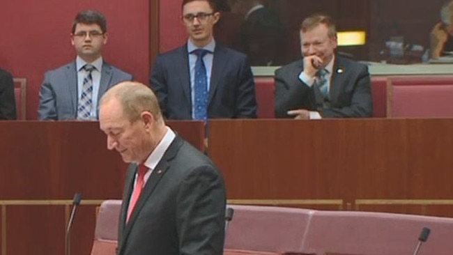 Speechwriter Richard Howard (far right) watches Senator Fraser Anning deliver his first speech to the Senate.