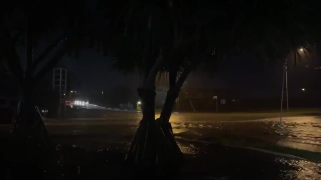 Cars driving through flash-flooding on Taylor St and Hillyard St outside Office Works, Pialba.