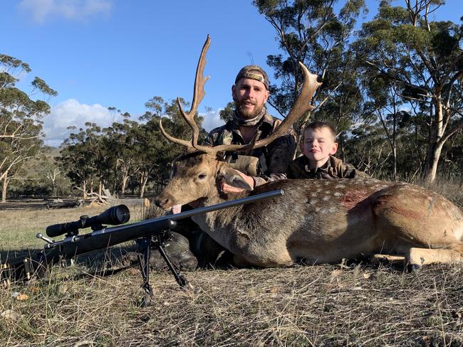 SA based hunter Zach Williams with his step son Aidan, 7, on a hunting trip with a deer. Picture: Supplied