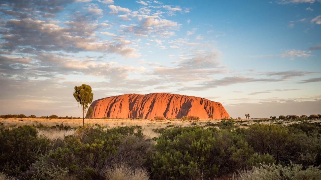 Tourists are flocking to Central Australia to climb Uluru.