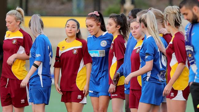 Players from Skye United womens soccer club become emotional as they take to the field for a minutes silence at Monbulk. Picture: Stuart McEvoy.