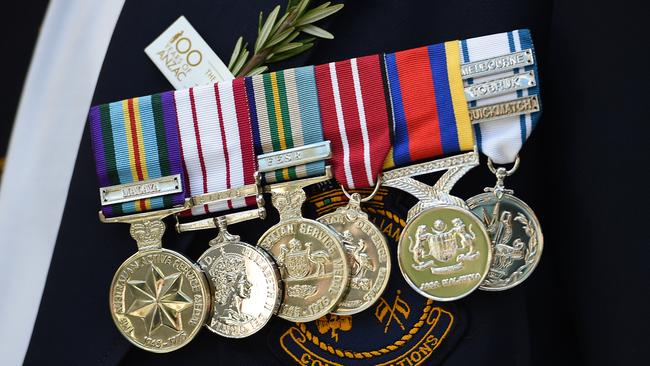 Medals are seen worn by an ex-serviceman during the Anzac Day march in Sydney, Monday, April 25, 2016. This year marks the 100th anniversary of the first Anzac Day service. (AAP Image/Dan Himbrechts) NO ARCHIVING