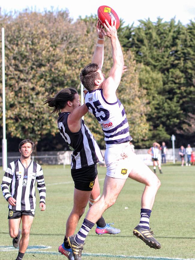 Matthew Knox climbs high to mark for Macedon. Picture: Aaron Cook