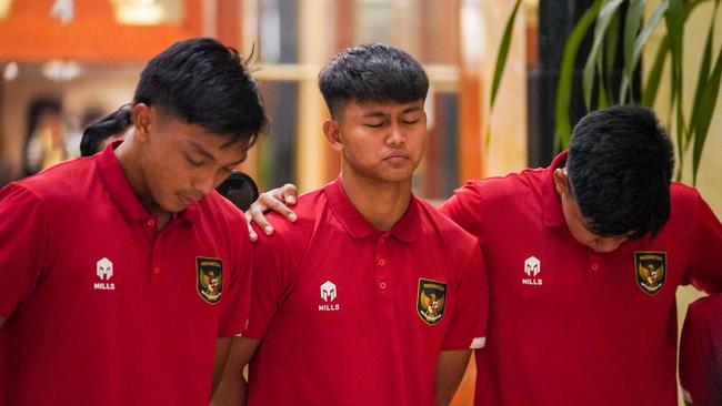 Members of Indonesia's Under-20 team mourn the loss of the cup. Picture: AFP