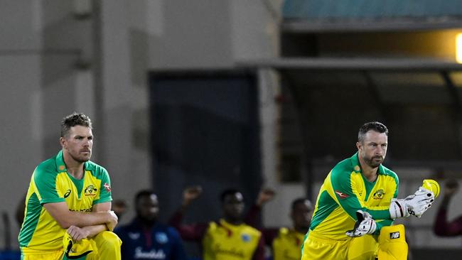 Aaron Finch and Matthew Wade of Australia kneel for Black Lives Matter during the 2nd T20I between Australia and West Indies. Picture: Randy Brooks / AFP