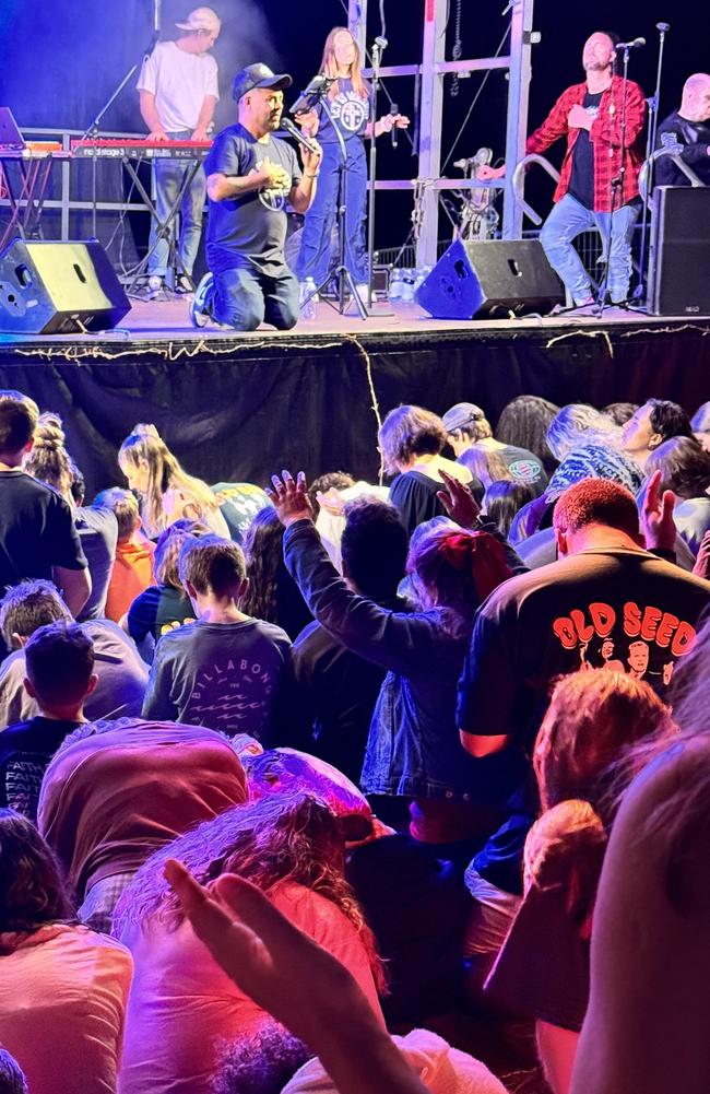 Daniel Hagen, of Fire Church on the right of the stage during the altar call at the end of the Sean Feucht-led service on the Sunshine Coast.