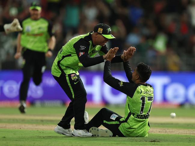 Sangha celebrates the key wicket of Glenn Maxwell with Thunder skipper David Warner. Picture: Robert Cianflone/Getty Images