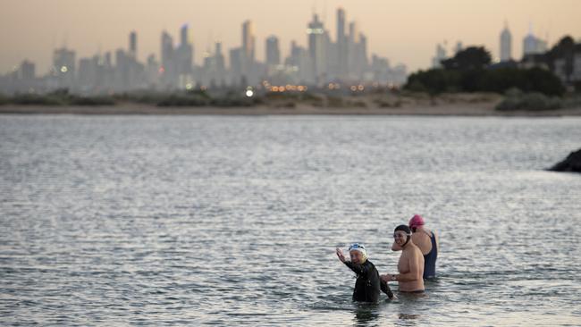 Simon Plant (left) swimming with Keith Badger and John Scanlon. Picture: Naomi Jellicoe