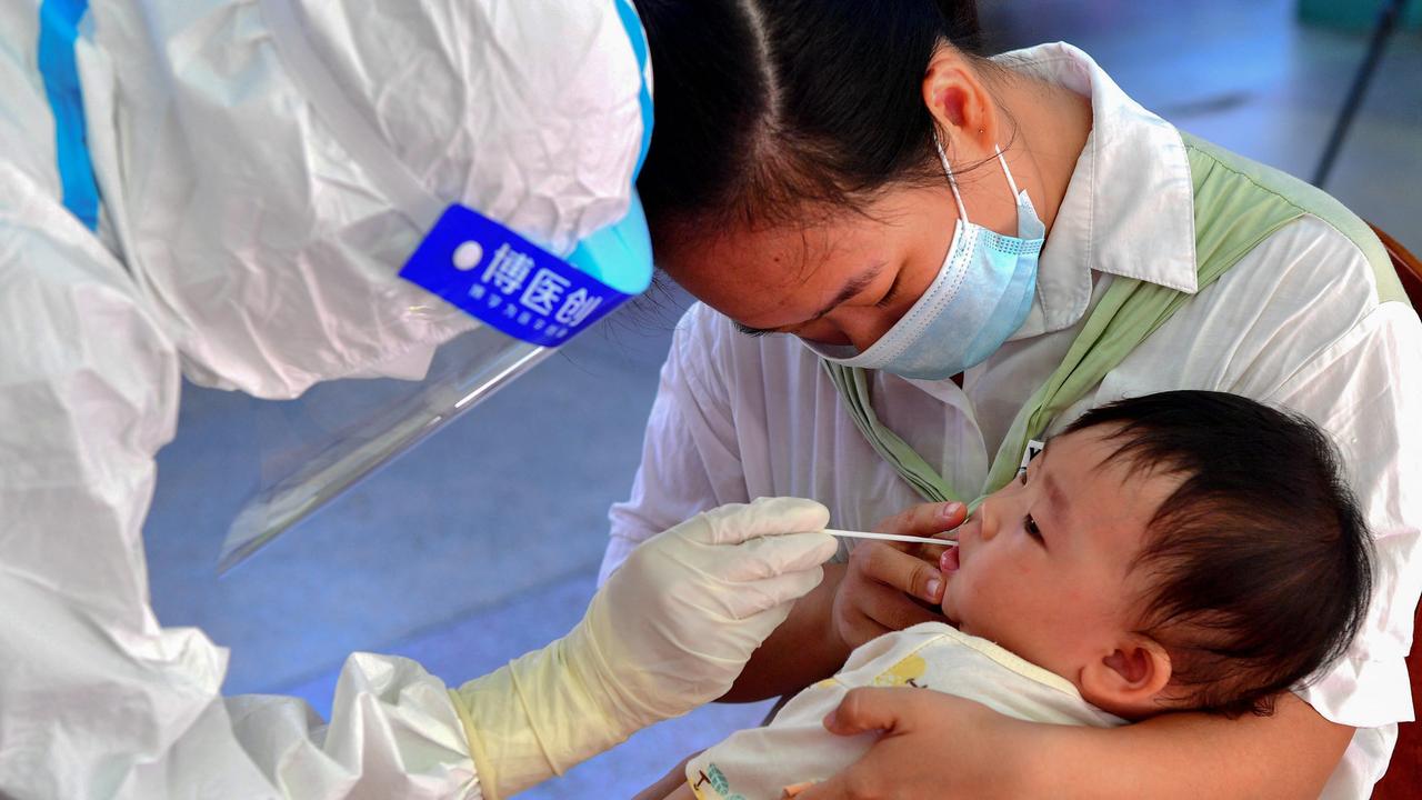 A young child undergoes a nucleic acid test for Covid-19 in Putian City, China, which will vaccinate children from the age of three. Picture: CNS/AFP