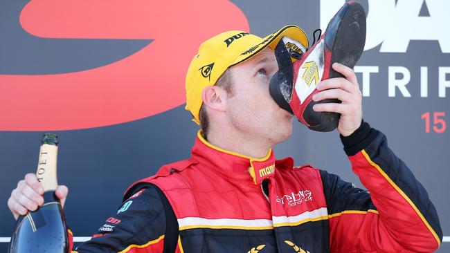 Dave Reynolds sinks a shoey after winning the Darwin Triple Crown in June. Picture: Tim Hunter.