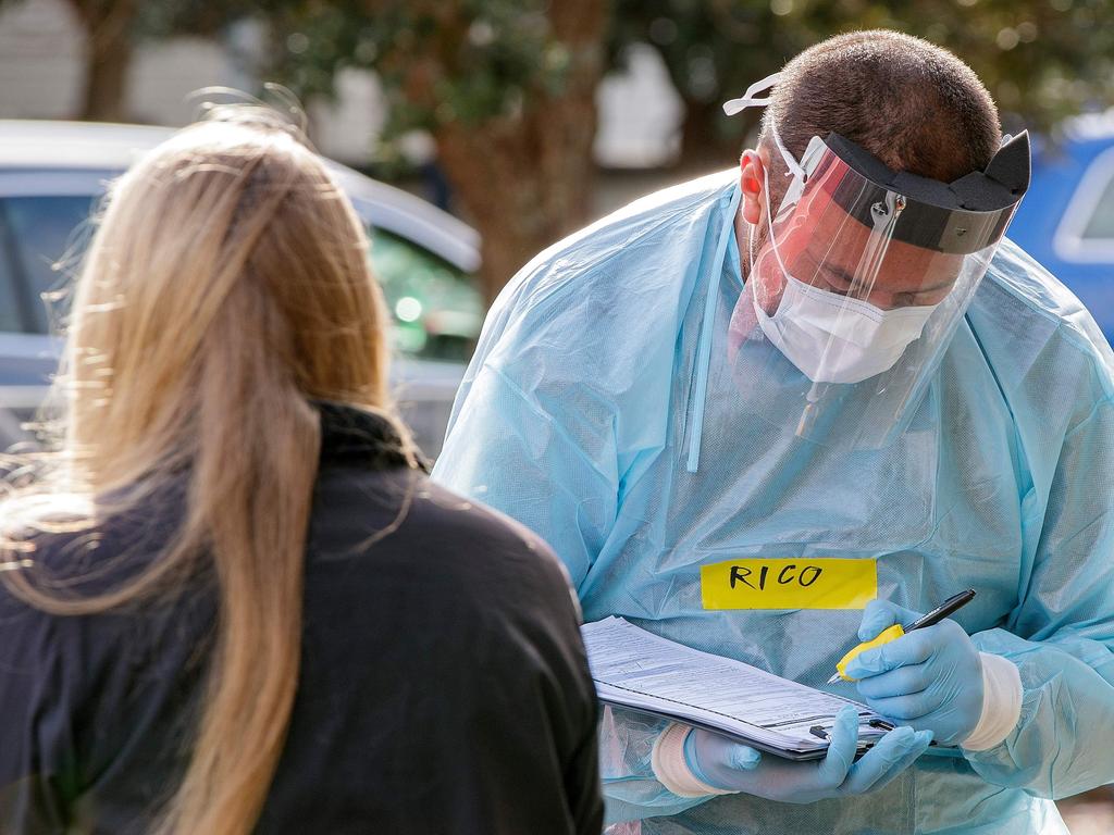 A health worker takes details at a COVID-19 testing station set up in Auckland. A new coronavirus case has been reported in the city. Picture: AFP