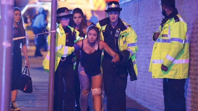 Police and other emergency services are seen near the Manchester Arena after reports of an explosion. Picture: Joel Goodman/LNP