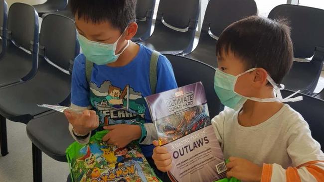 9-year-old Thomas and 5-year-old Andrew received toys and stationery upon their arrival in Darwin. Picture: Jenny Zhu