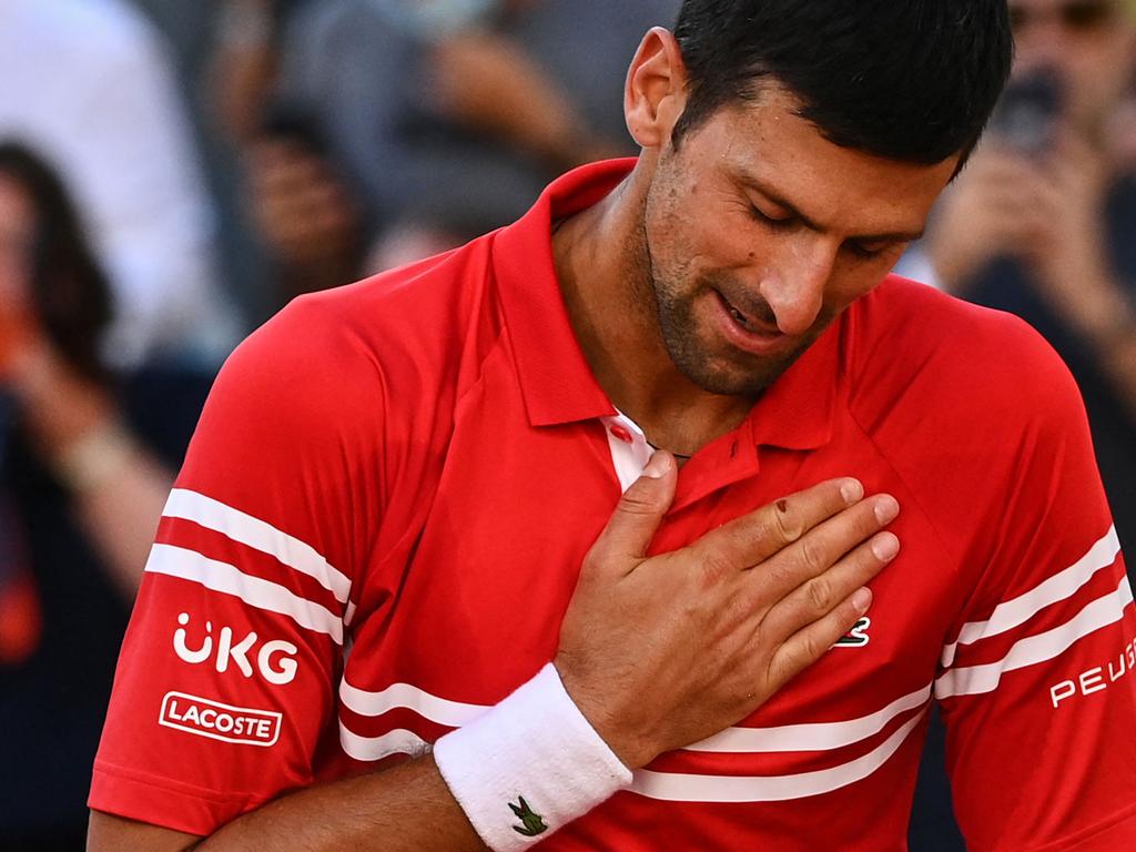 (FILES) In this file photograph taken on June 13, 2021, Serbia's Novak Djokovic celebrates after winning against Greece's Stefanos Tsitsipas at the end of their men's final tennis match on Day 15 of The Roland Garros 2021 French Open tennis tournament in Paris. - Novak Djokovic could be barred from playing in the French Open under current rules after the sports ministry said on January 17, 2022, that elite sportspeople would need to be vaccinated to perform in France.The ministry said a new vaccine pass, approved by the French parliament on January 16, "applies to everyone, to volunteers and to elite sportspeople, including those coming from abroad, until further notice." (Photo by Anne-Christine POUJOULAT / AFP)
