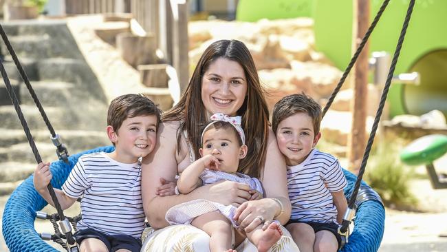 Christian, 4, Isaiah, 4, Brooklyn, 9mnths, and mum Alexandra Yin on the swing at the Jervois St Playground. Picture: AAP/Roy VanDerVegt