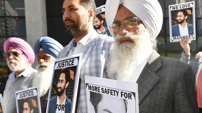 Ramsaroop Sharma (right), the father of the slain bus driver Manmeet Alisher, is seen protesting with family and friends outside the Supreme Court in Brisbane. Picture: Darren England