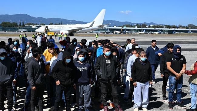 Guatemalan migrants deported from the United States walk down the runway after arriving at the Guatemalan Air Force Base in Guatemala City on January 10, 2025. Guatemala closes 2024 with more than 61,000 deported from the US. (Photo by Johan ORDÃÃEZ / AFP)