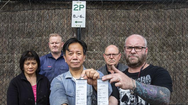 Hotco workers Vananh Nguyen, Thomas Beggs, Wenneng Liu, Greg Wilson and Peter Leca are fuming after Bayside Council issued cars with $85 fines. Photo: Valeriu Campan