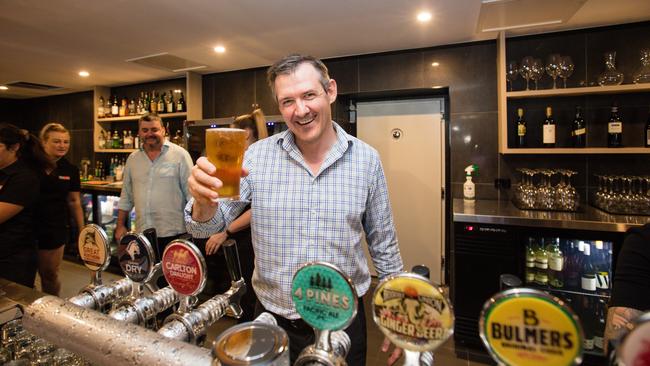 Chief Minister Michael Gunner pours a schooner at the revamped Cavenagh Hotel with owner Paul Palmer. Picture: Glenn Campbell