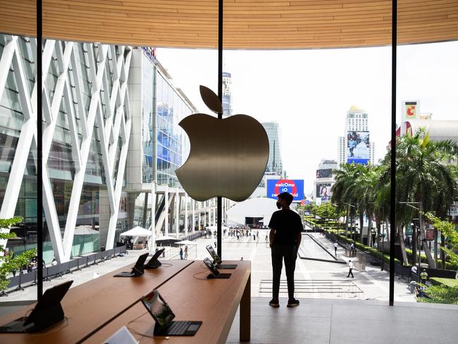 BANGKOK, THAILAND - JULY 31:  Thai visitors look out the large windows at Apple Central World on the stores opening day on July 31, 2020 in Bangkok, Thailand. Apple's second, and largest, retail location opened today at the Central World shopping mall in Bangkok, Thailand.ÃÅ  Crowds lined up in socially distanced queues after being temperature scanned upon entry to the area. Using contact tracing applications and allowing only 30 visitors in at a time, Apple Central World, provided a safe environment to allow product fans to experience their new retail location.  (Photo by Lauren DeCicca/Getty Images)