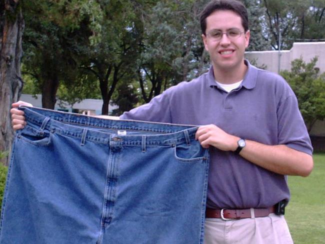 FILE - In this Aug. 7, 2001 file photo, Jared Fogle holds up a pair of jeans he used to wear after losing weight in Albuquerque, N.M. Subway benefited hugely from Fogle’s weight loss story. Now the sandwich chain needs to figure out how to prevent him from overshadowing its future. (AP Photo/Ivan Chavez)