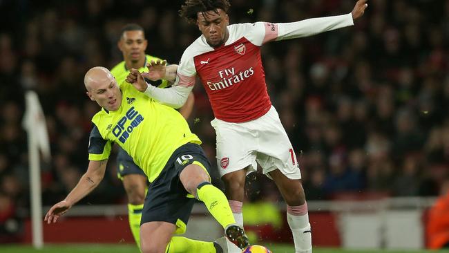 Arsenal's Nigerian striker Alex Iwobi (R) vies with Aaron Mooy (L) who injured his knee in the Premier League clash. (Photo by Daniel LEAL-OLIVAS / AFP) 