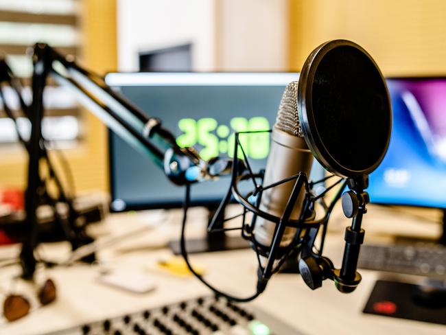 Microphone and mixer at the radio station studio broadcasting news. iStock