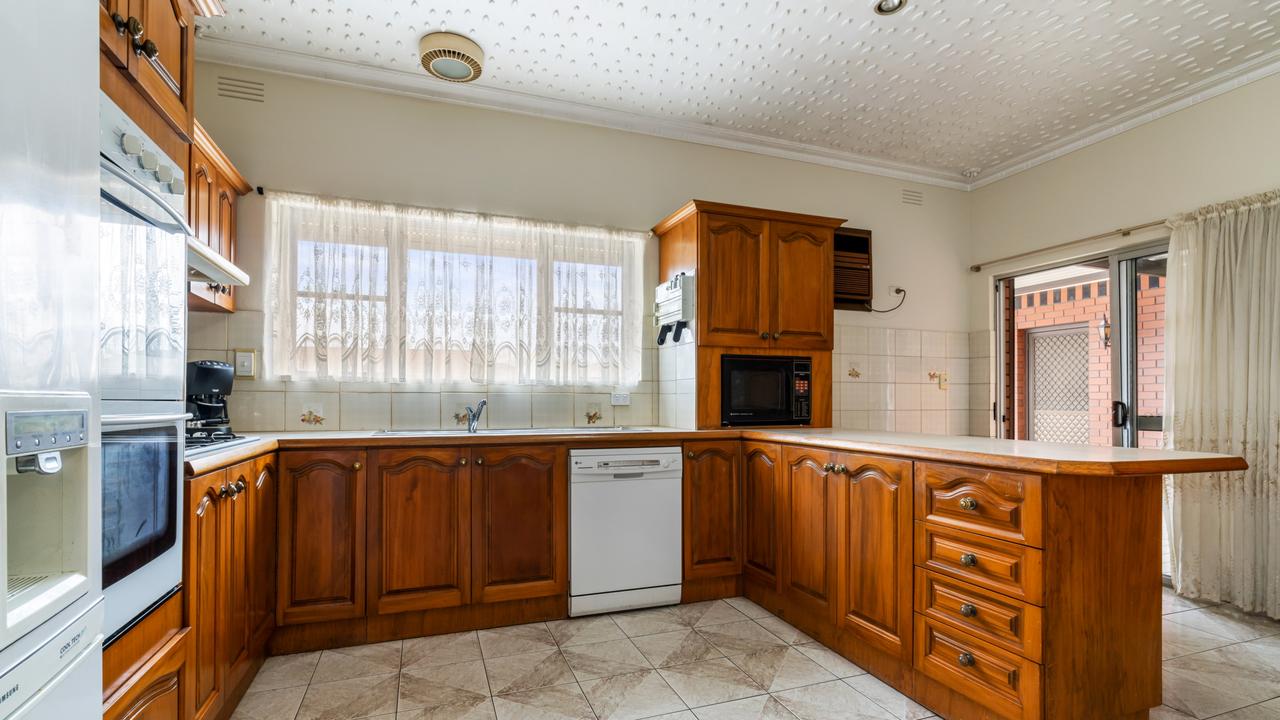 The kitchen’s ceiling has small, cut-out pieces of plaster affixed to it to create an artistic effect.