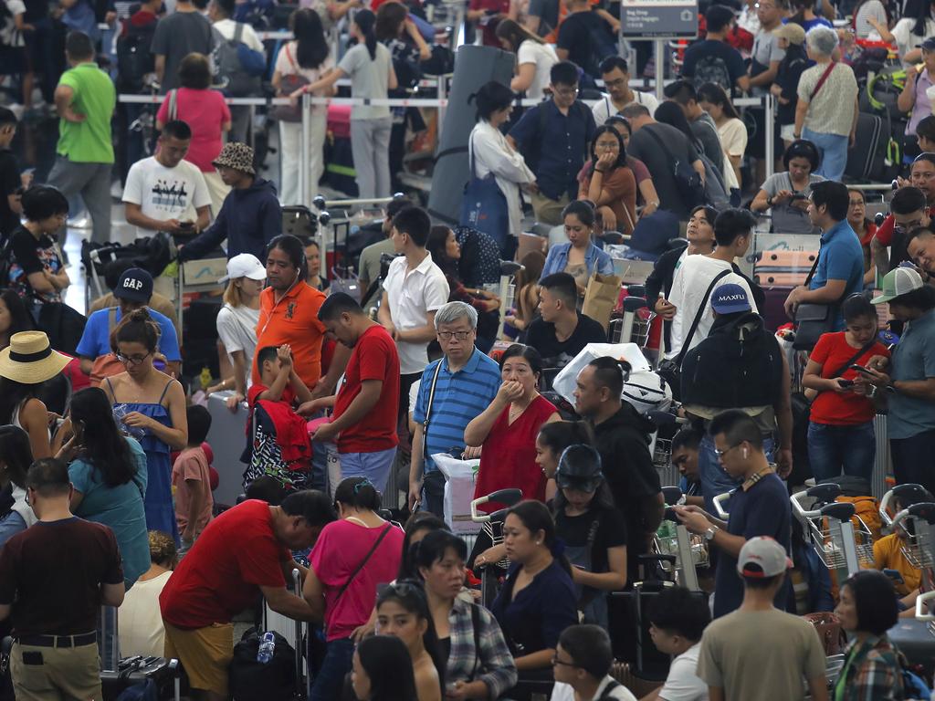 Stranded travellers gather at the departure hall of the Airport in Hong Kong. Picture: AP