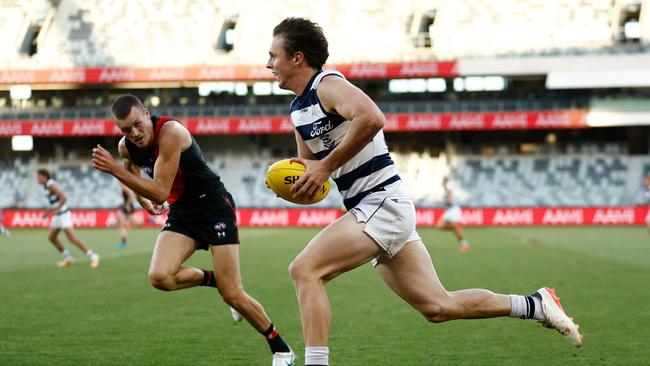 Max Holmes rebounds off of half back for Geelong in its 2024 AFL AAMI Community Series match against Essendon on March 1. Picture: Michael Willson/AFL Photos via Getty Images.