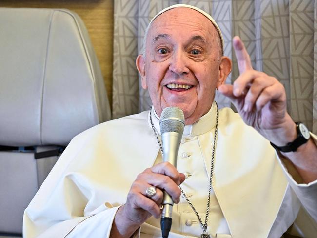 Pope Francis speaks aboard the plane flying from Nur-Sultan to Rome following his three-day visit to Kazakhstan on September 15, 2022. (Photo by Alessandro DI MEO / POOL / AFP)