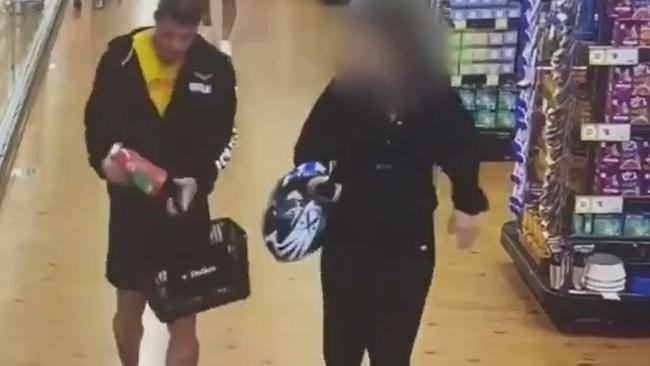 CCTV footage shows the Comanchero bikie Danny Rapley with a woman inside a supermarket. Source: 9 News.