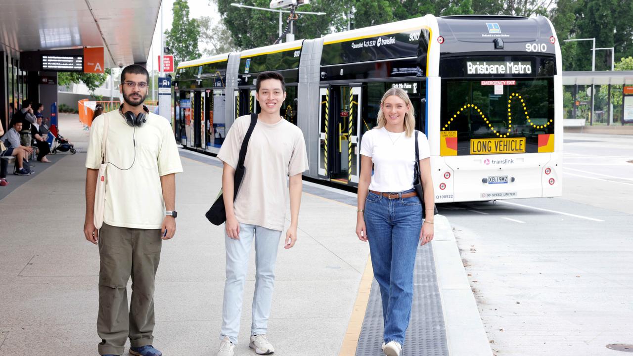 Aviral Sharma from St Lucia, Brandon Loon from Toowong, Ava Kenafake from Sheldon, with the Brisbane Metro Electric Bus, at UQ St Lucia during a trial. Photo: Steve Pohlner