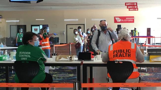 Travellers from South Australia arrive for processing at Alice Springs Airport, November 18.