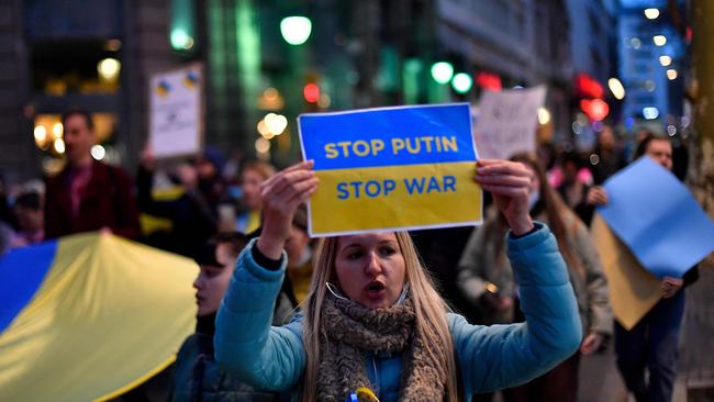 A demonstrator during a protest against Russia's military operation in Ukraine. (Photo by Pau BARRENA / AFP)