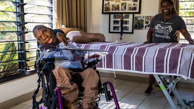 NDIS participant Fabian Bush with carer Nafisalou Mbeyla in his room in a Somerville group home in Darwin.