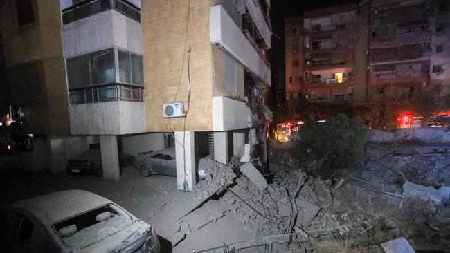 This picture shows damaged cars and buildings following an Israeli air strike in the Haret Hreik neighbourhood of Beirut's southern suburbs. Picture: AFP