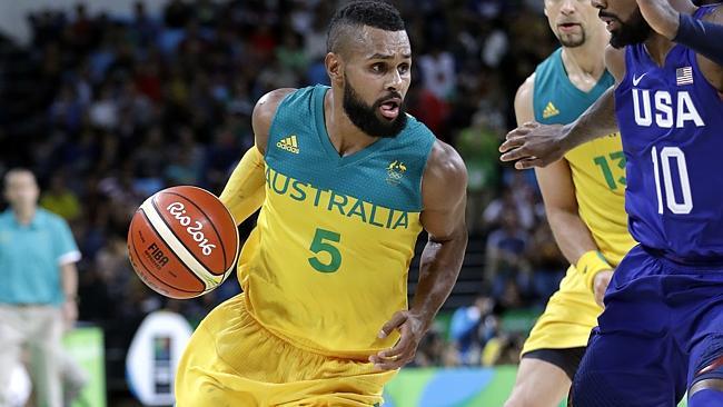 Australia's Patty Mills drives around United States' Kyrie Irving.