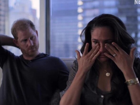 Meghan Markle wipes her eyes as a concerned Prince Harry looks on. Picture: Netflix