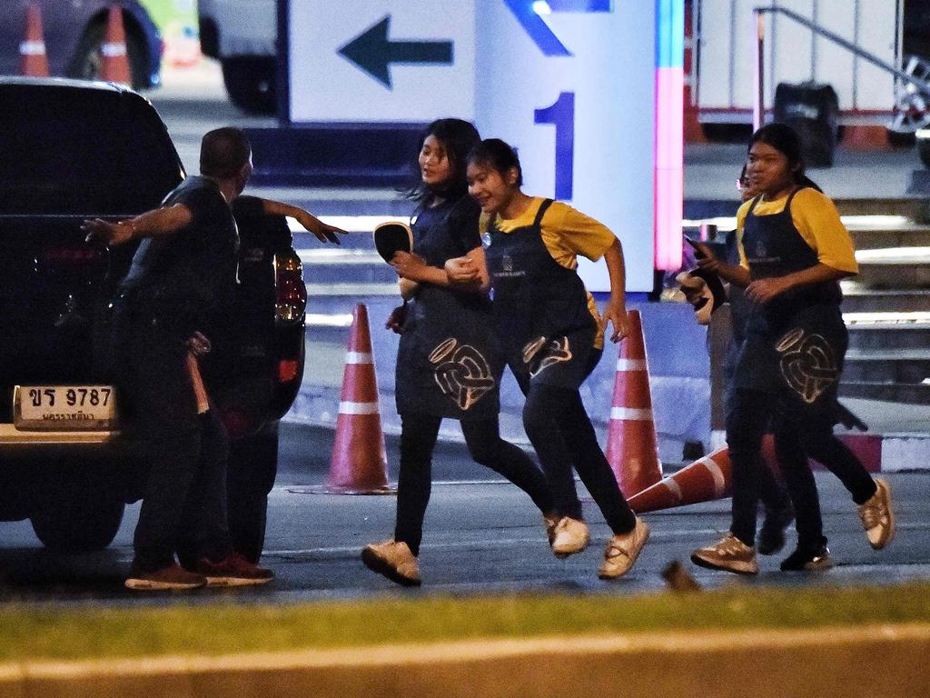 People run together as they are rescued by Thai commandos from Terminal 21 shopping mall. Picture: AFP