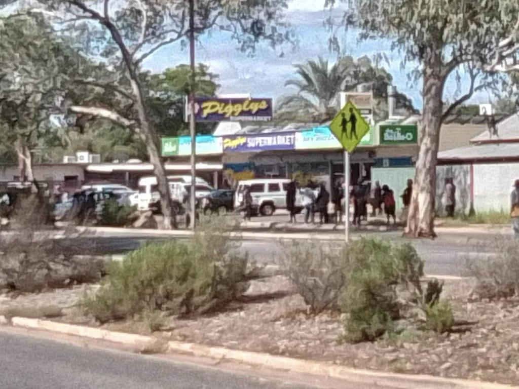 A big crowd gathers at Pigglys Gap Rd in Alice Springs, not long before curfew. Picture: Action for Alice