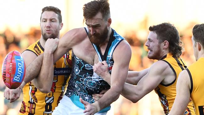 Charlie Dixon can’t evade James Frawley and Blake Hardwick in Tasmania on Saturday. Picture: AAP Image