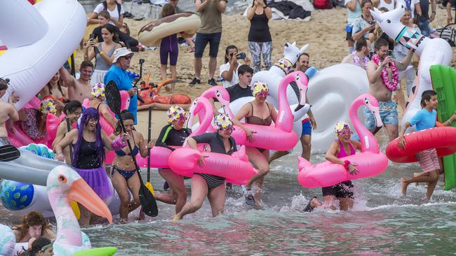 Participants hit the water at the start of the annual Manly Inflatable Boat Race at Shelly Beach at Manly on Sunday, 23 February, 2020. (AAP IMAGE / Troy Snook)